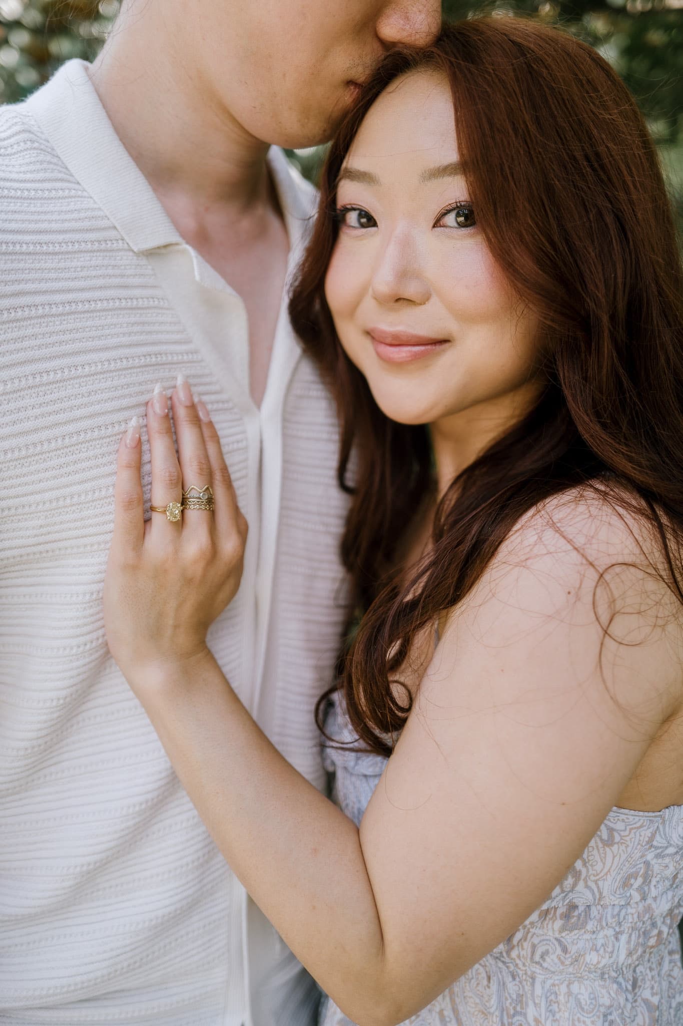 Close portrait of an engaged couple, the new ring front and center