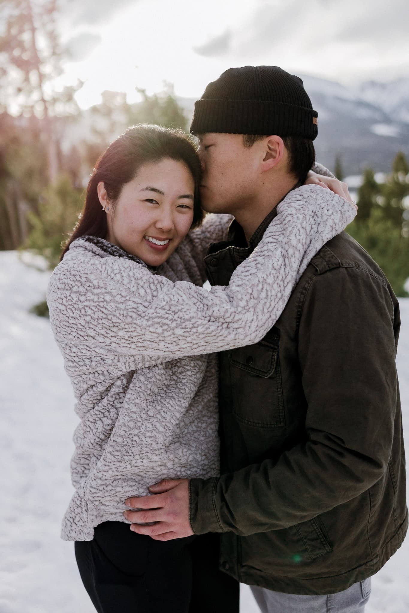 Couple hugging and smiling in the snow
