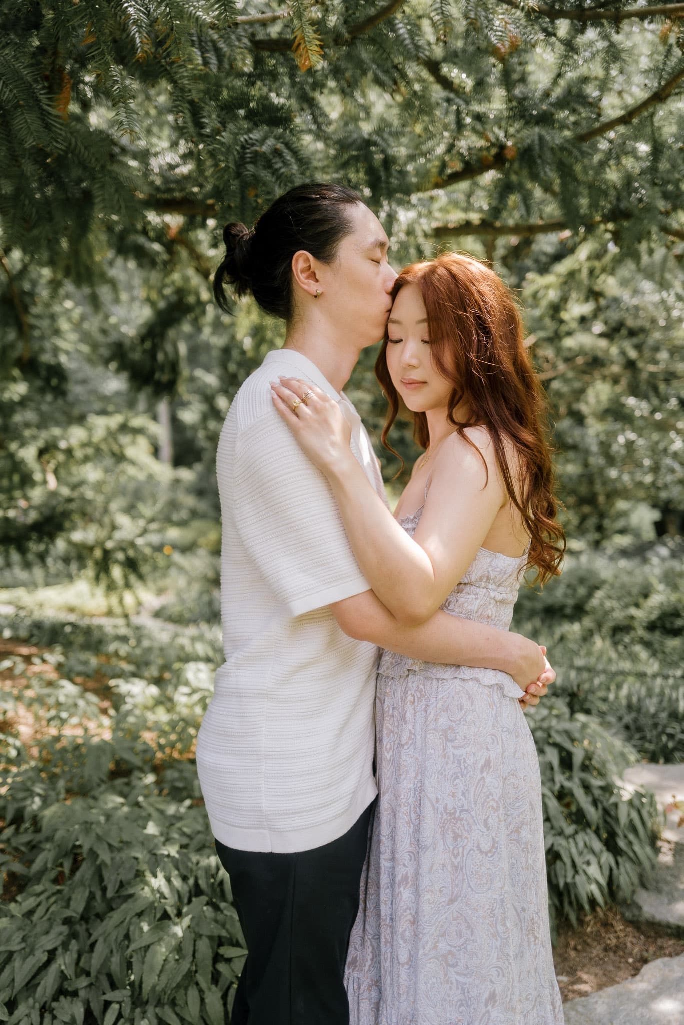 A kiss on the forehead among the garden greenery