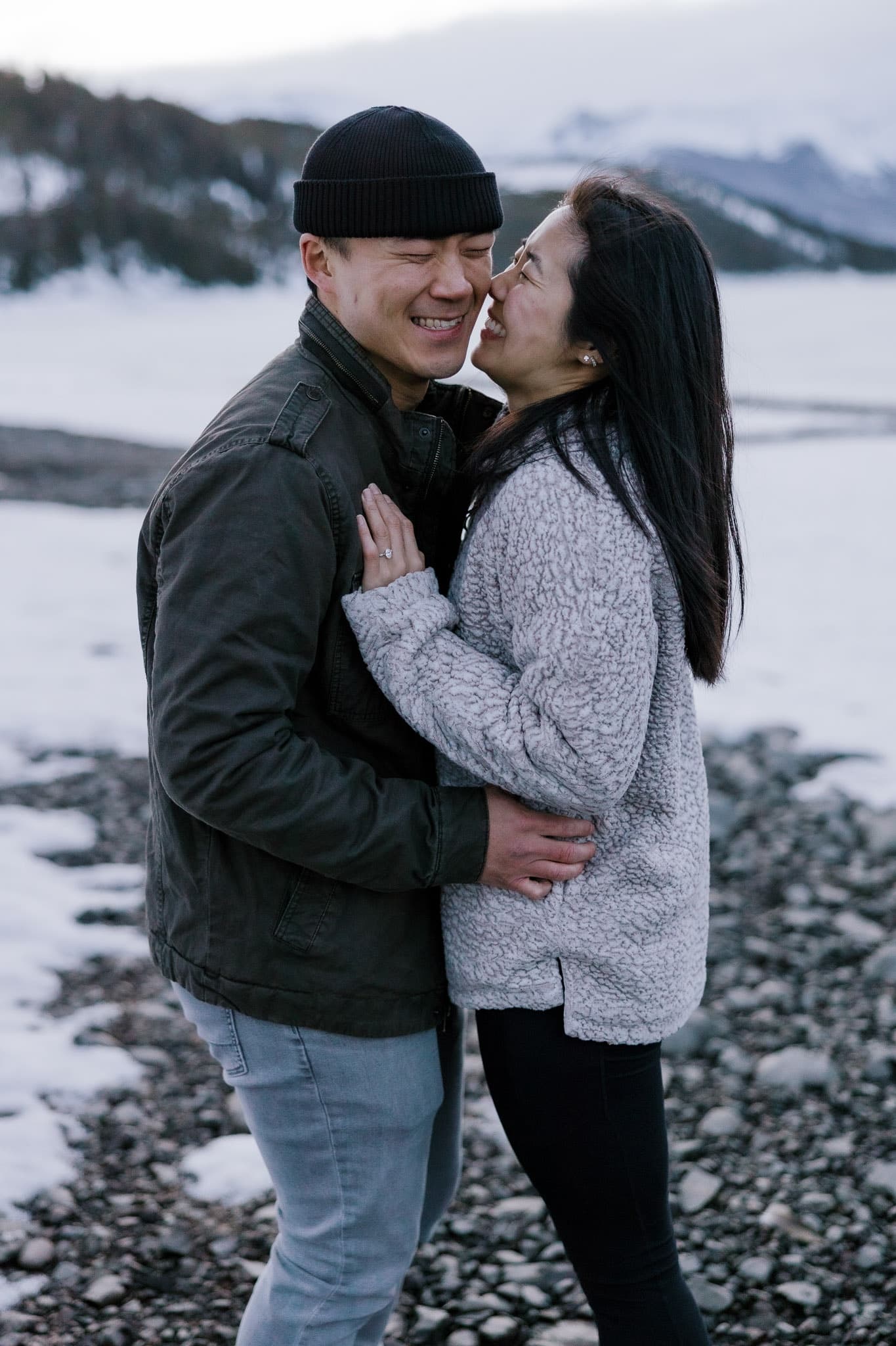 Couple sharing a laugh on the rocky lakeshore