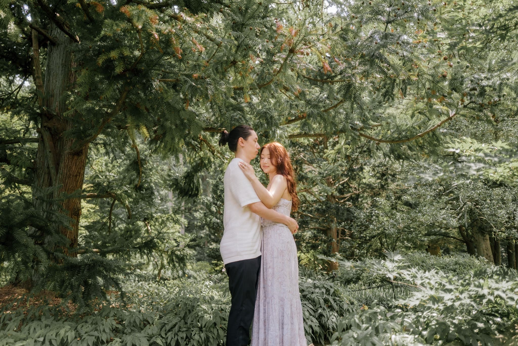 Couple embracing on a winding path through the garden