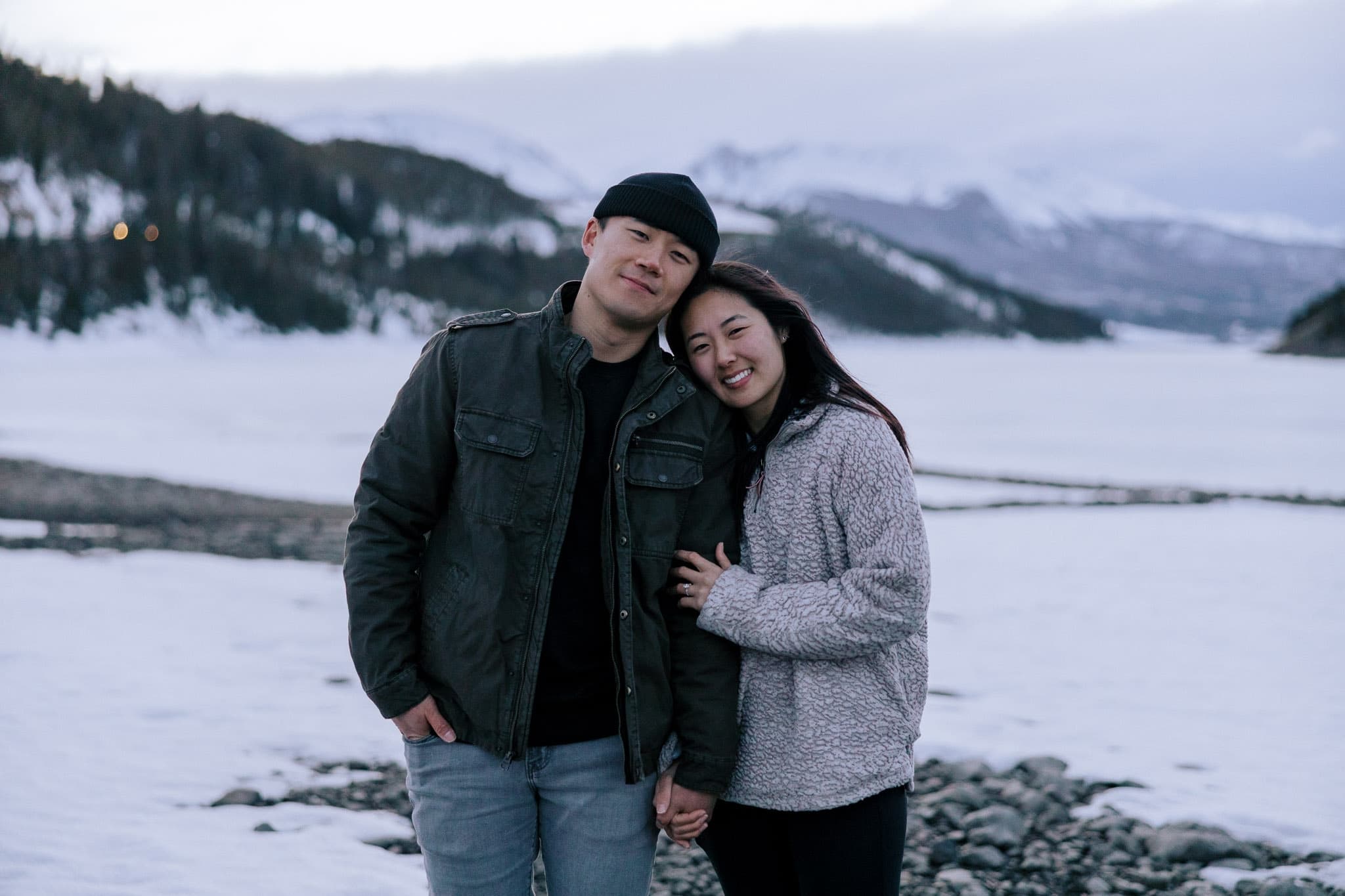 Couple smiling on the frozen lakeshore