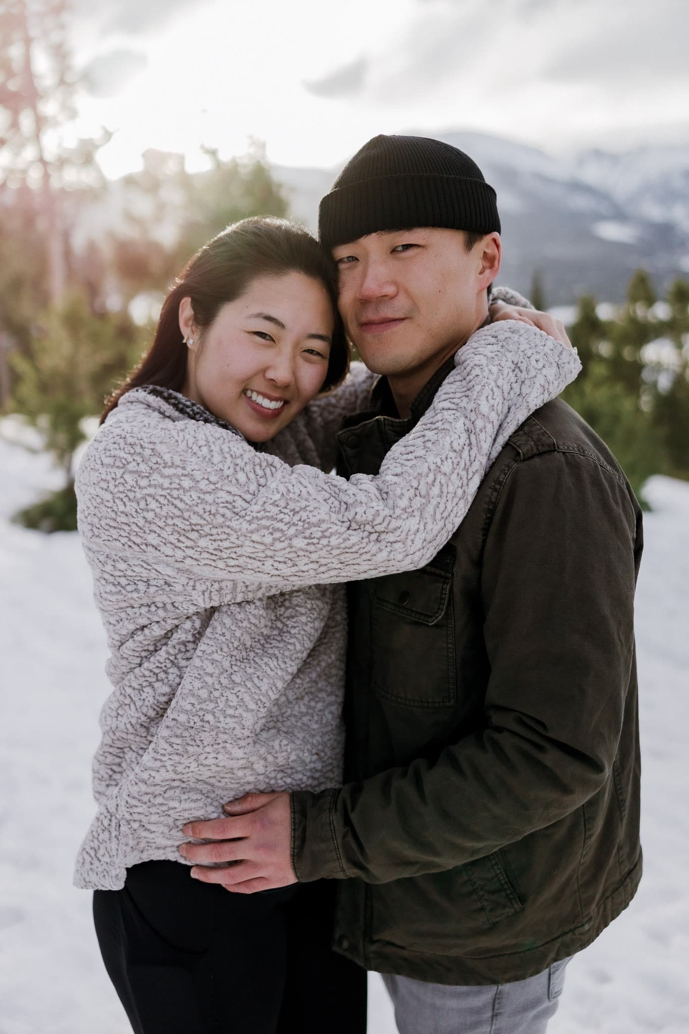 Couple cheek to cheek in the snow