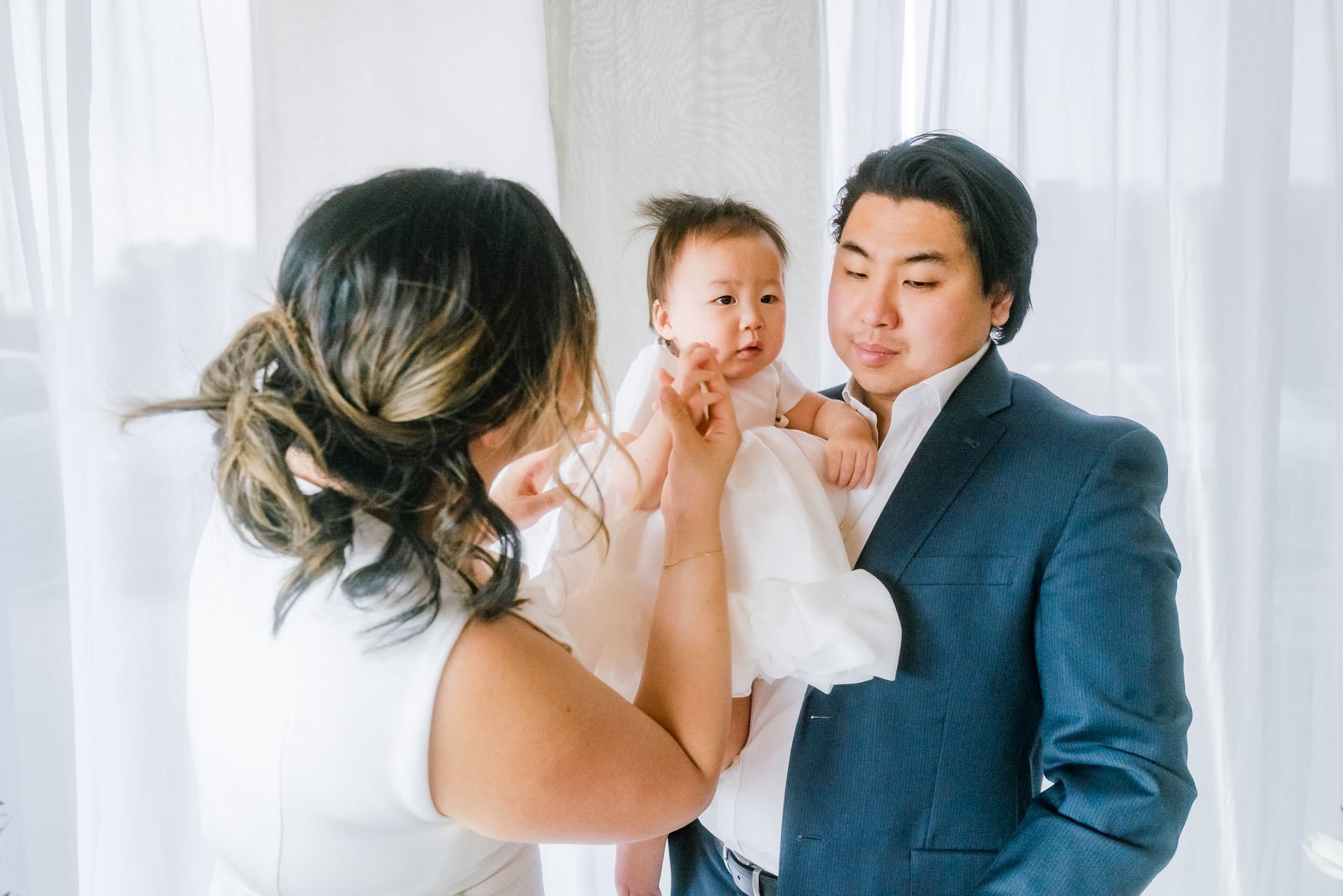 Parents holding their baby close at a first-birthday celebration