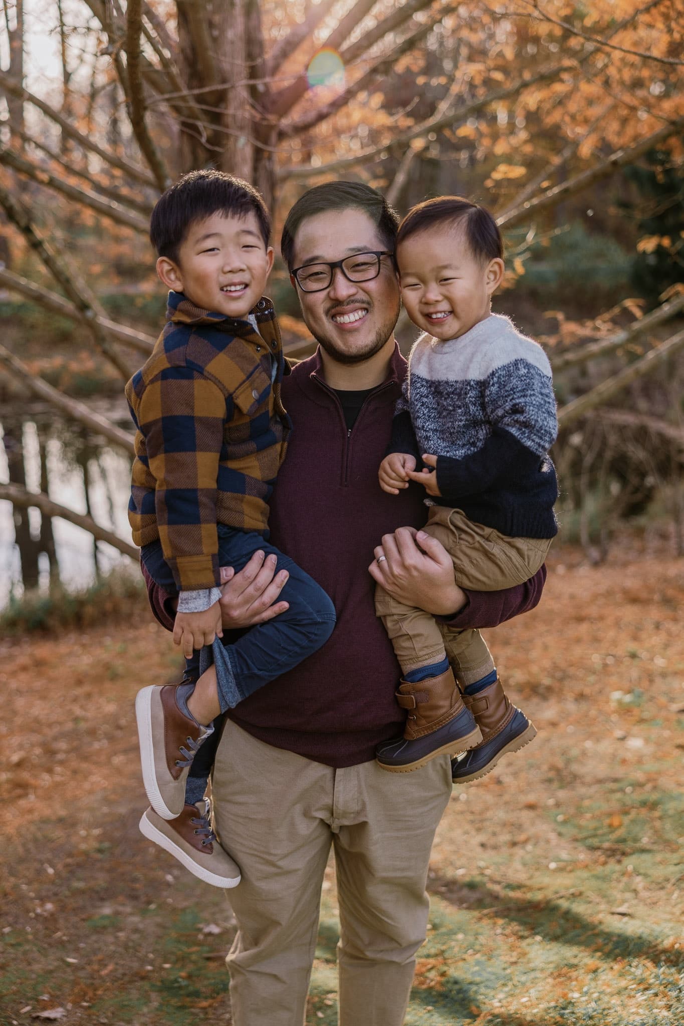 Parent holding two laughing children