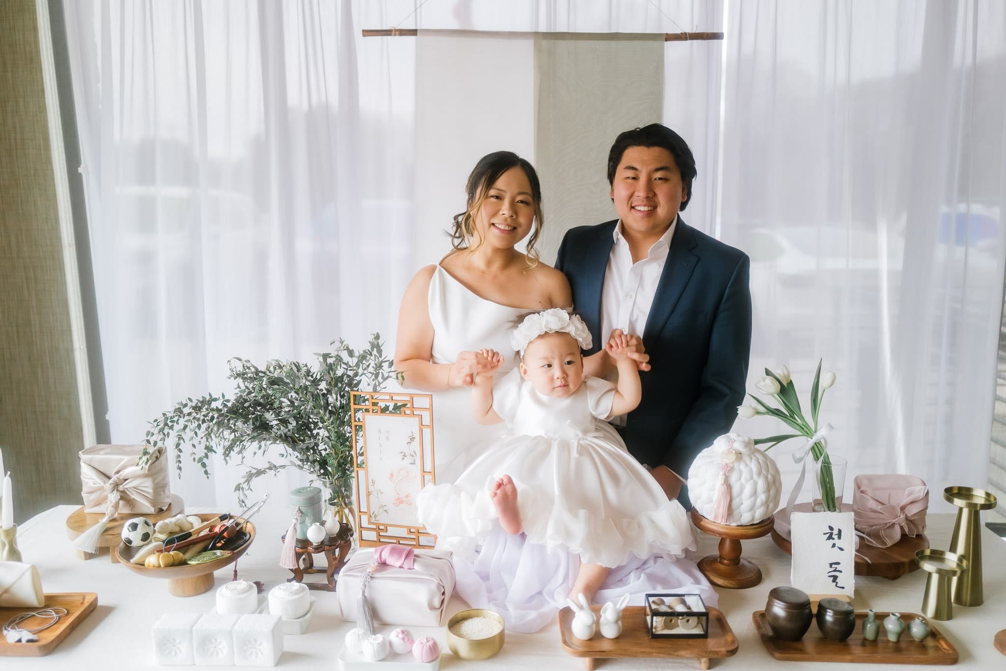 Parents with their baby at the decorated first-birthday table