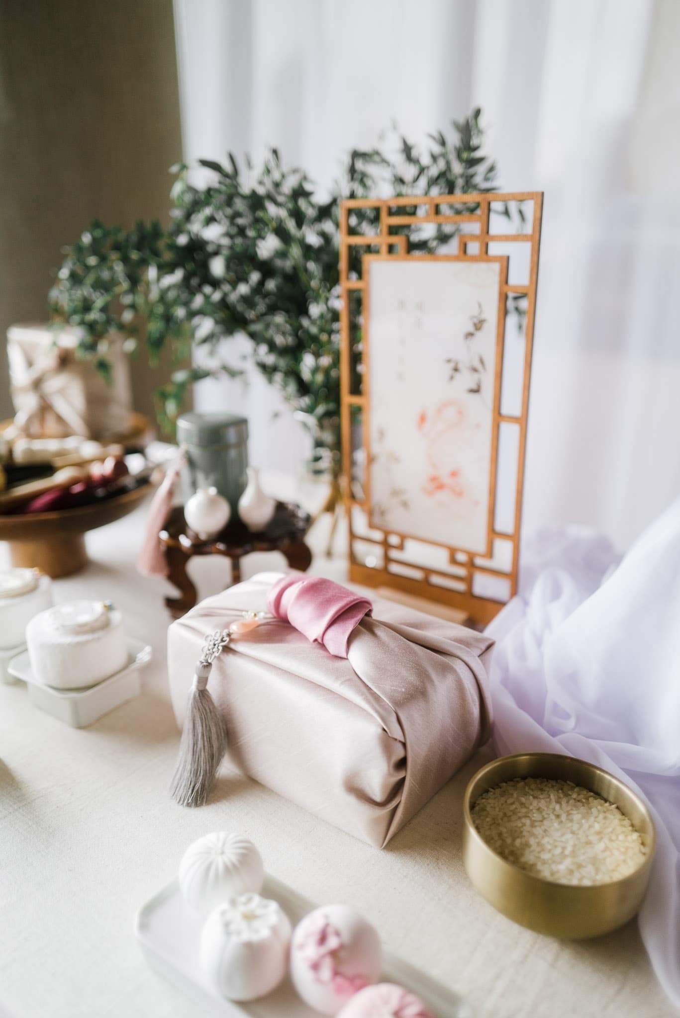 Traditional gifts and a painted screen on the first-birthday table