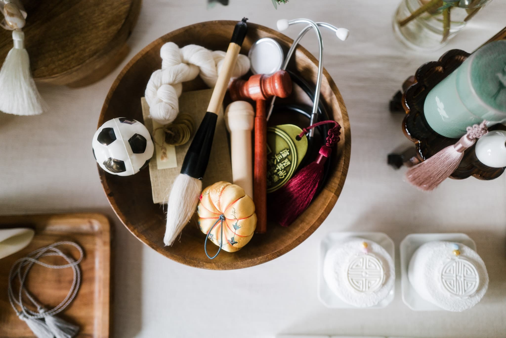 Keepsakes in a wooden bowl for the first-birthday tradition