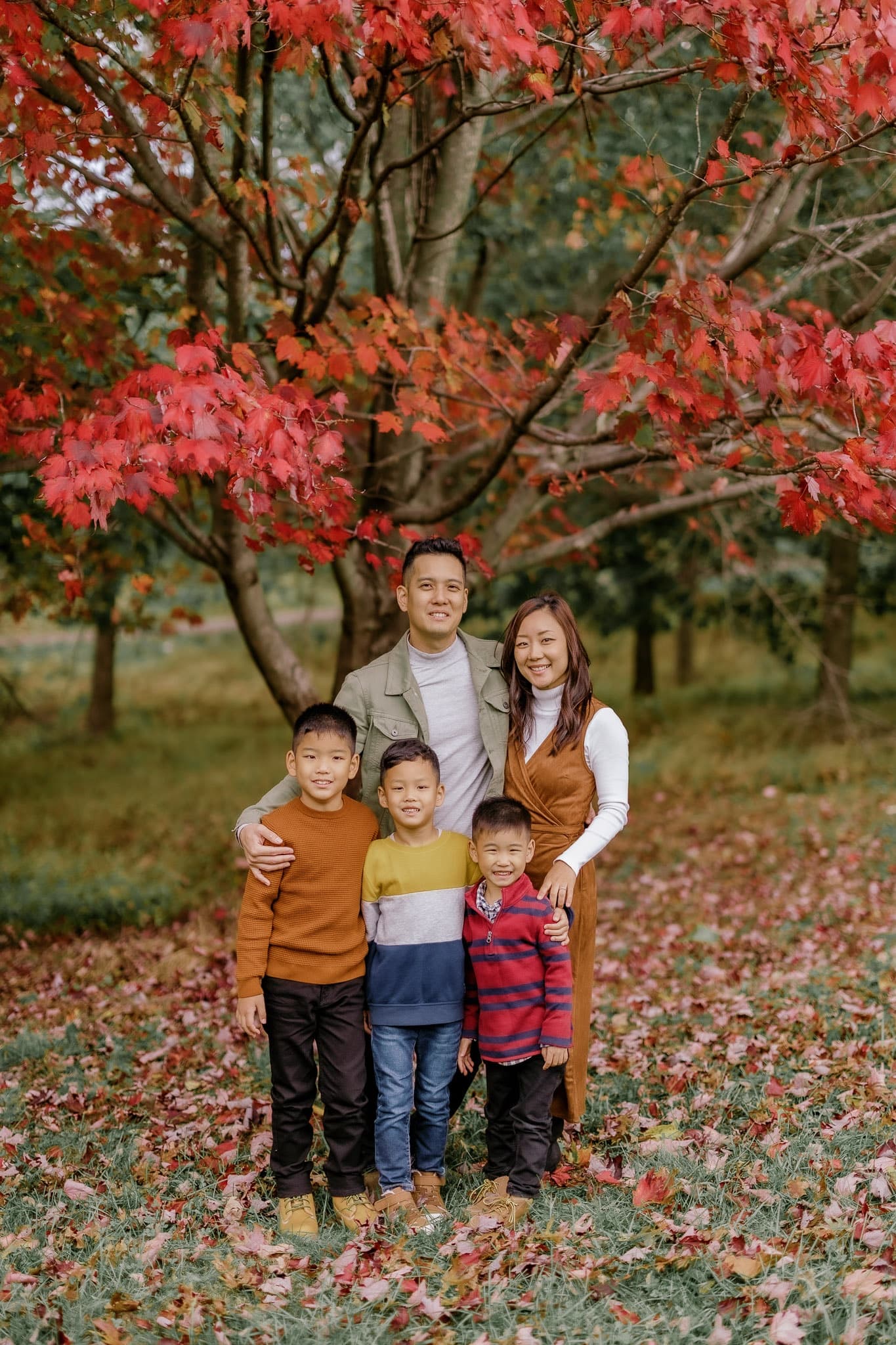 Family of five under a red maple tree