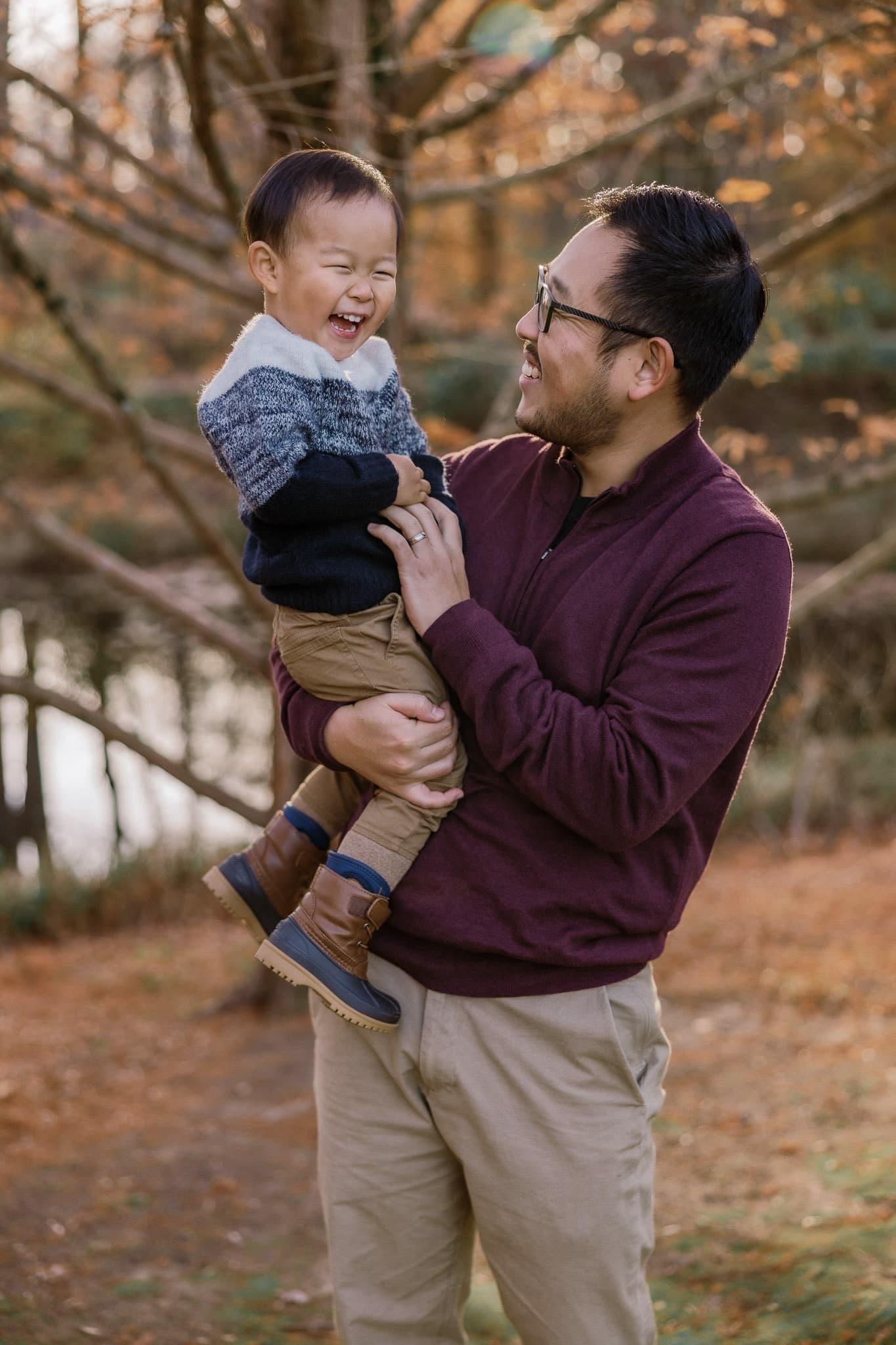 Parent lifting a giggling toddler
