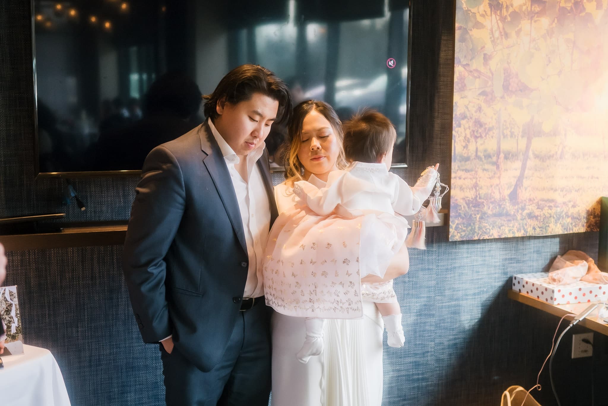 Family portrait with the baby in a softly lit room