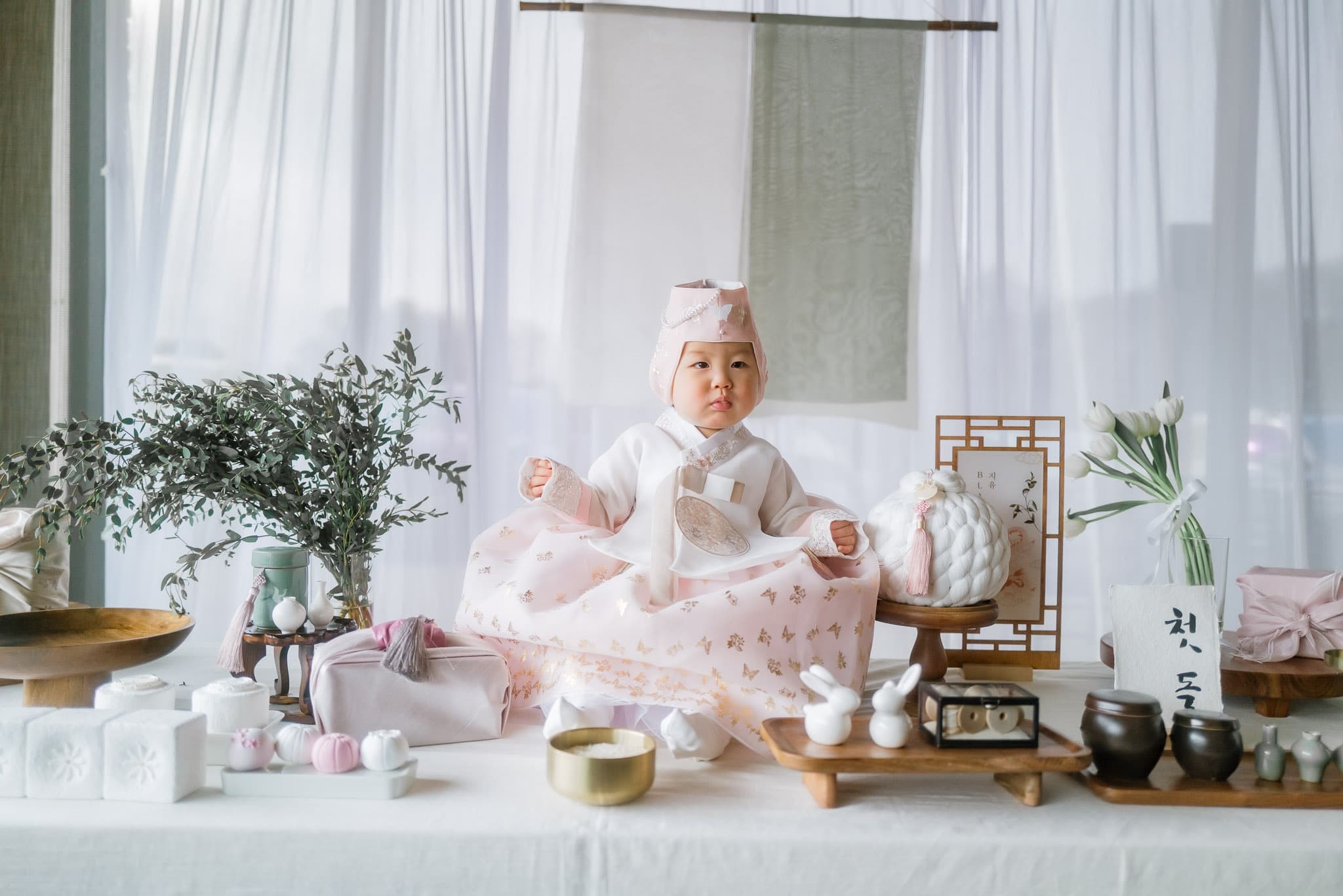 Baby in hanbok at the first-birthday table