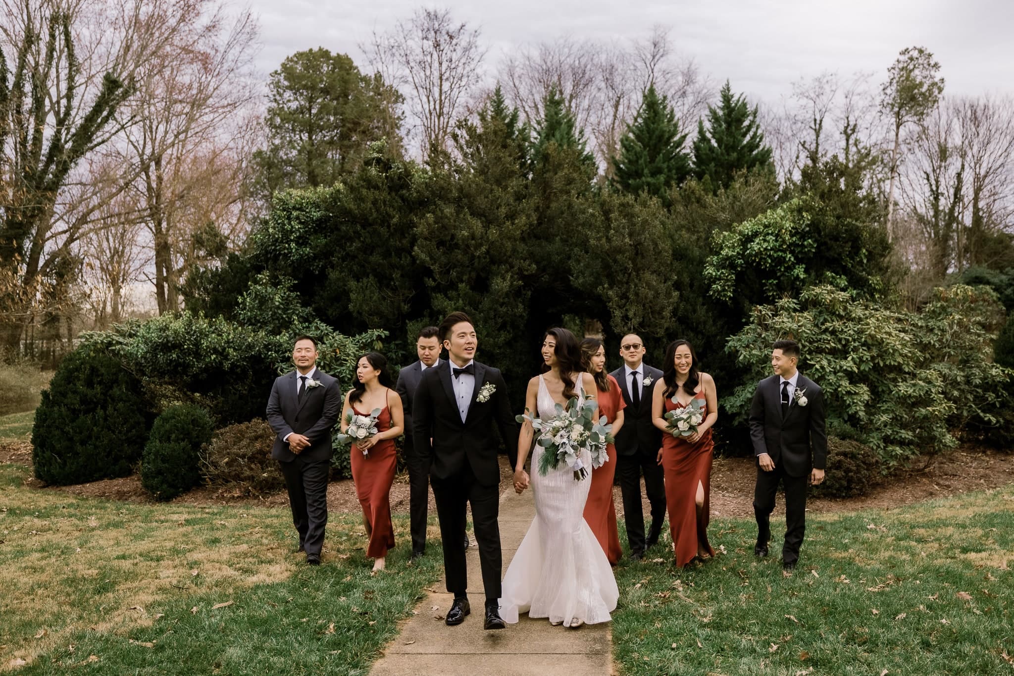 Wedding party walking across the lawn