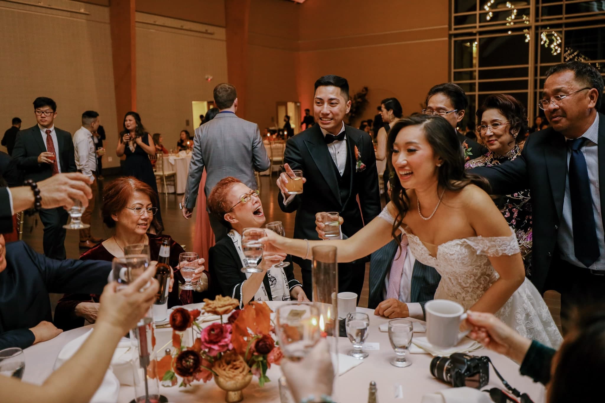 Bride raising a toast with guests at the reception