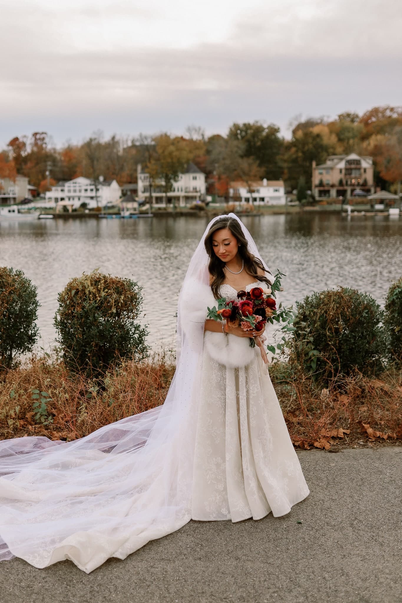 Bride with a long cathedral train by the water