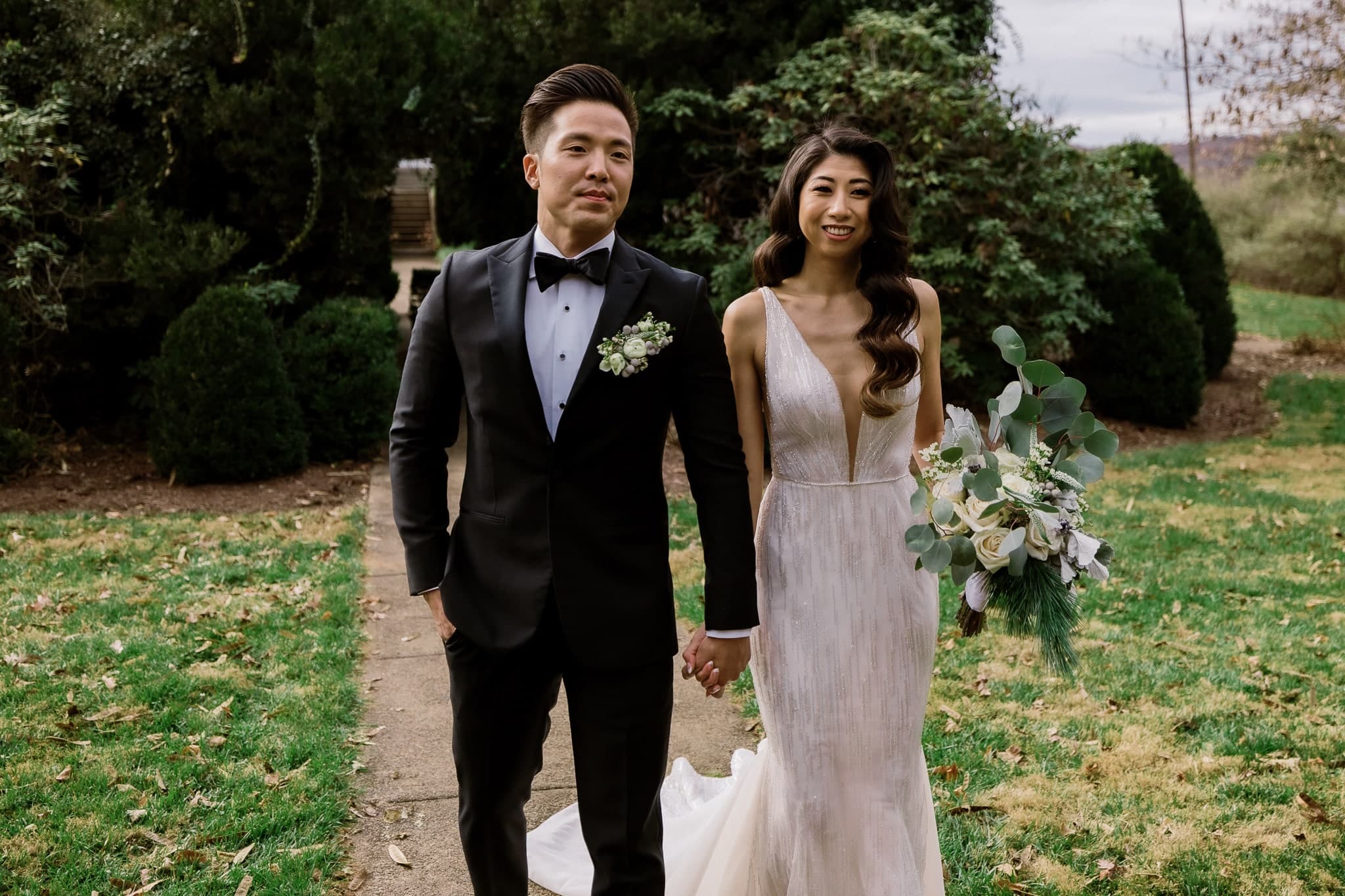 Couple walking arm in arm along the garden path