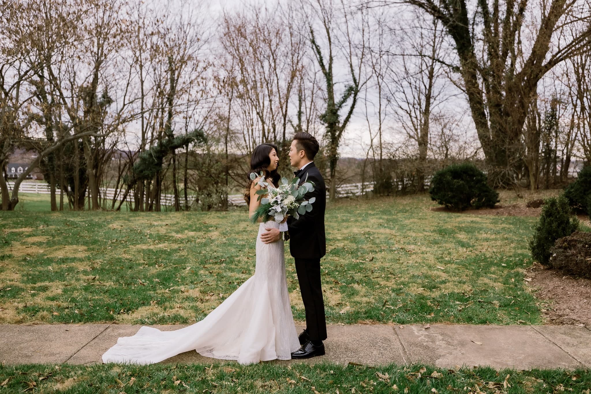 First-look embrace on the garden lawn
