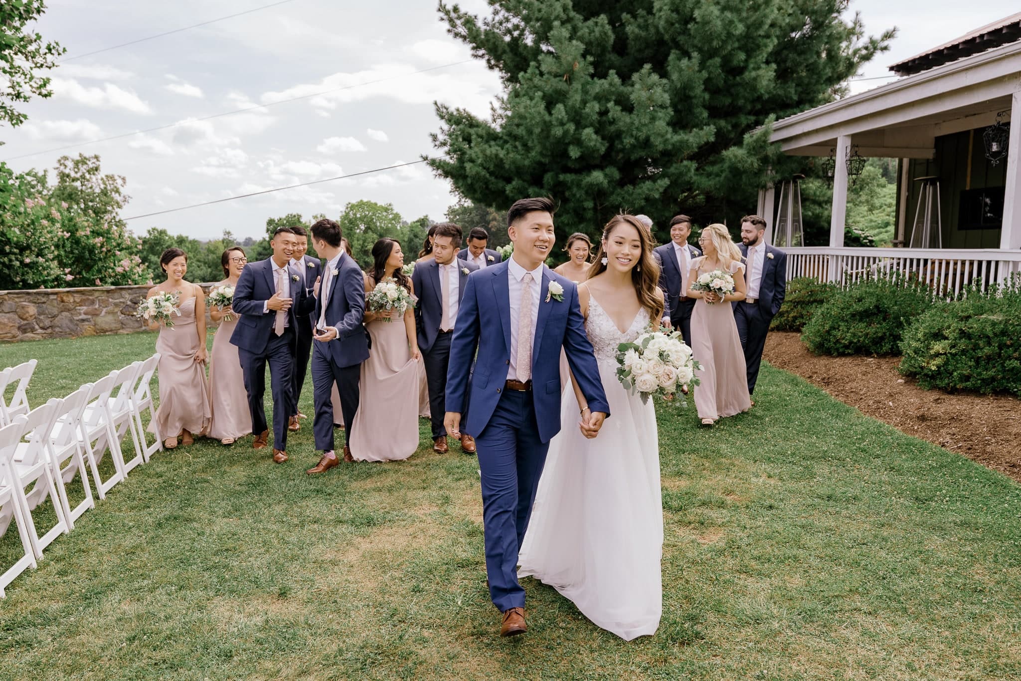 Couple walking ahead of the wedding party
