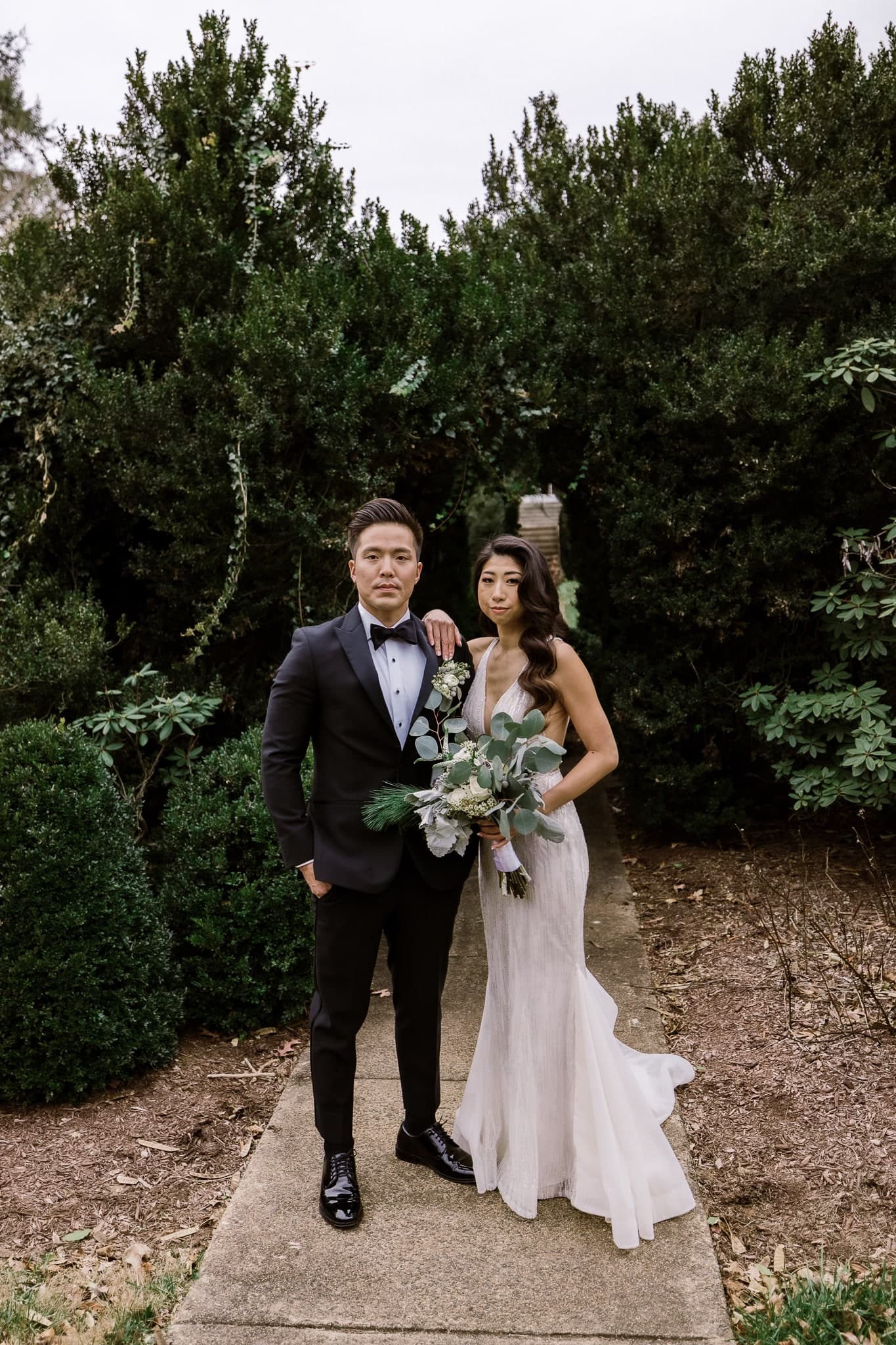 Couple standing together on a garden path