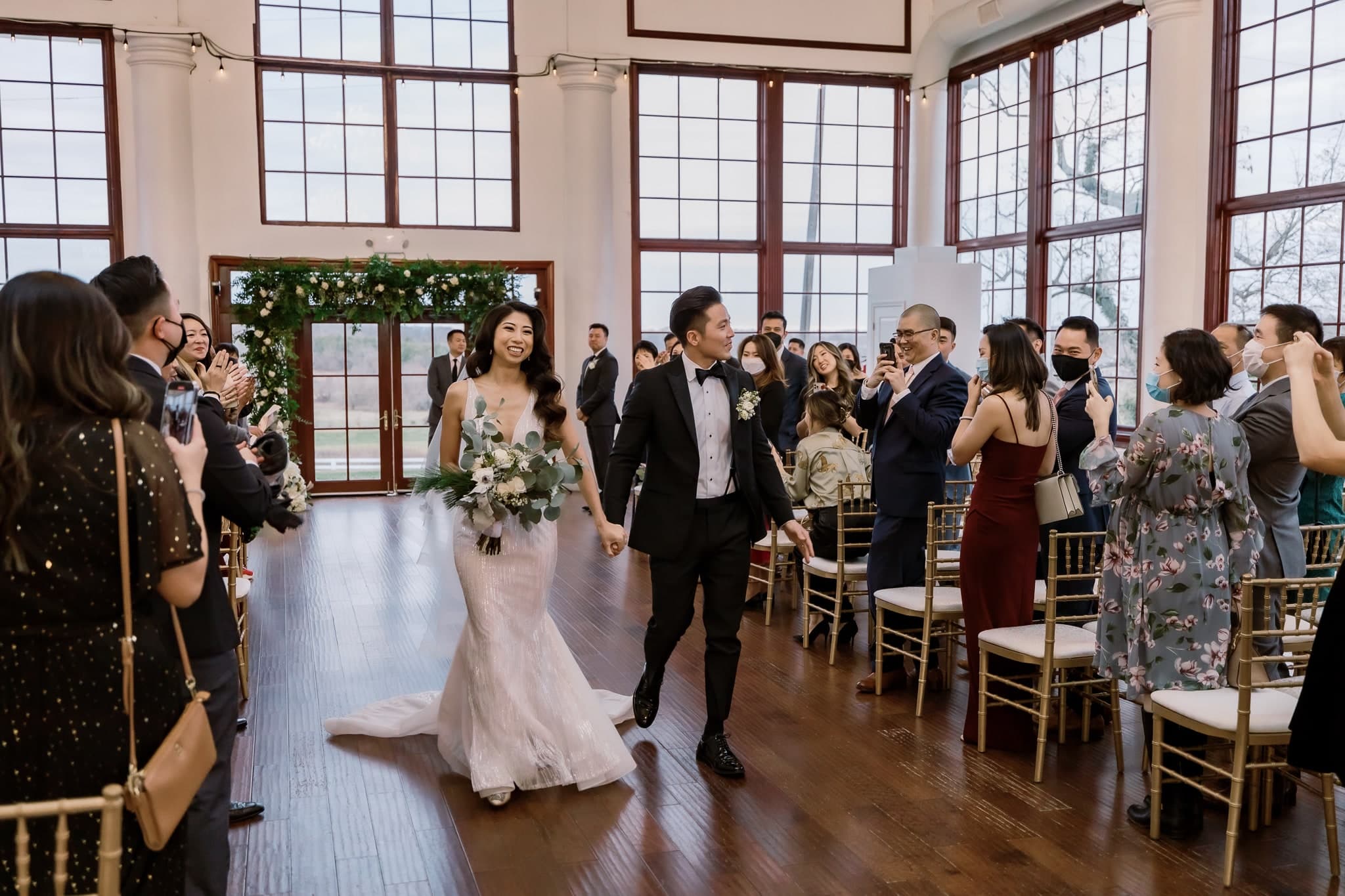 Newlyweds celebrating on their walk back up the aisle
