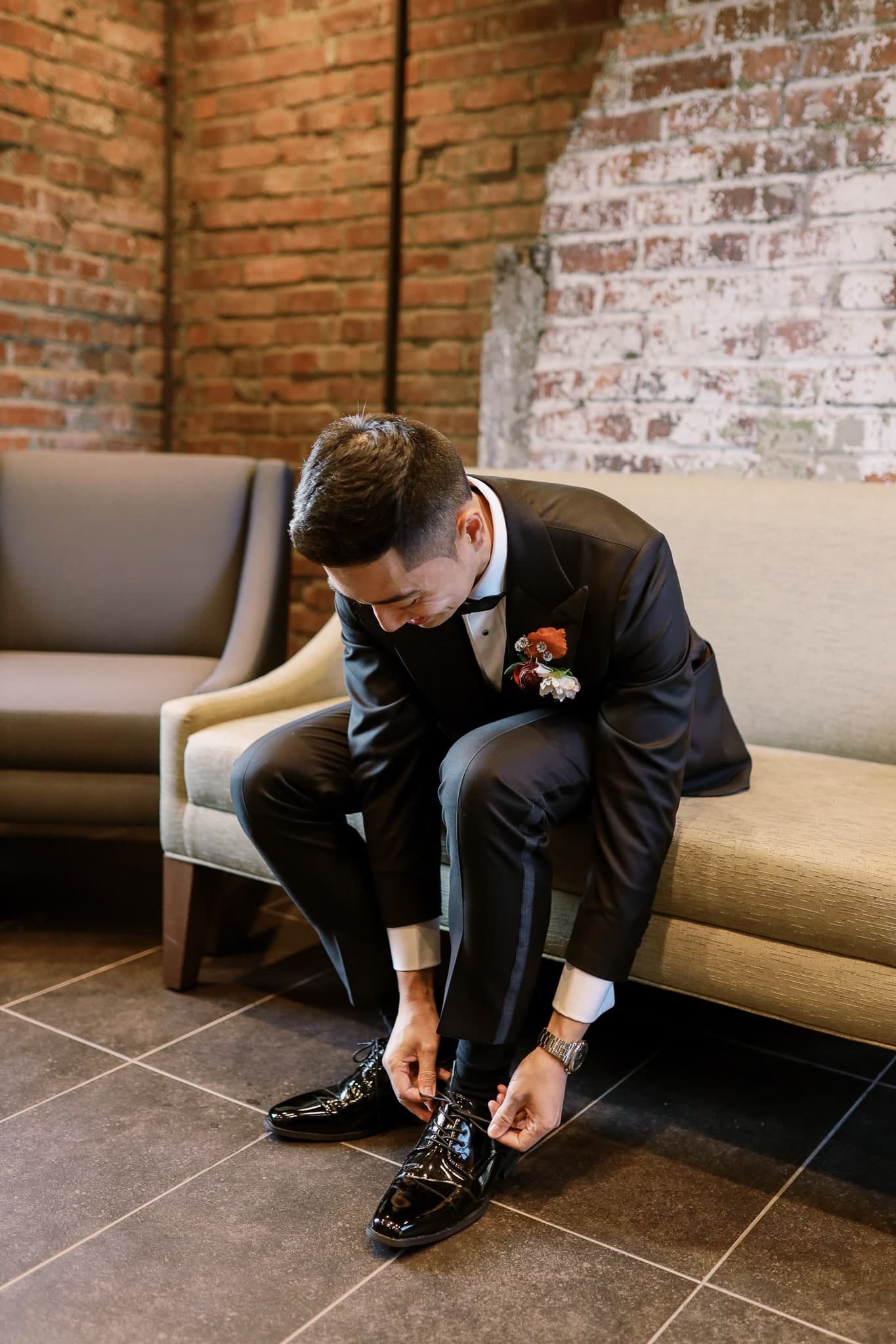 Groom tying his shoes before the ceremony