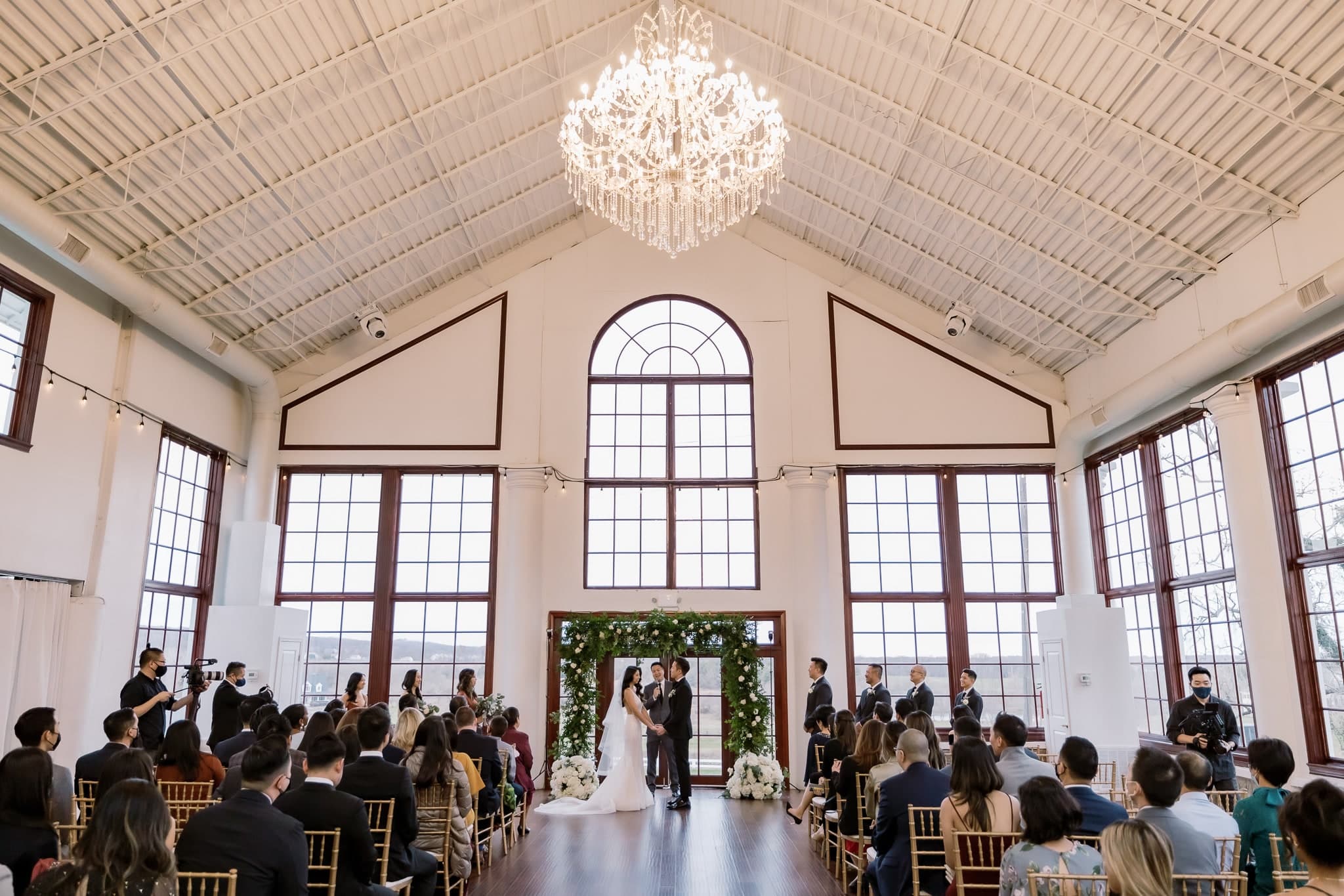 Glasshouse ceremony under the chandelier