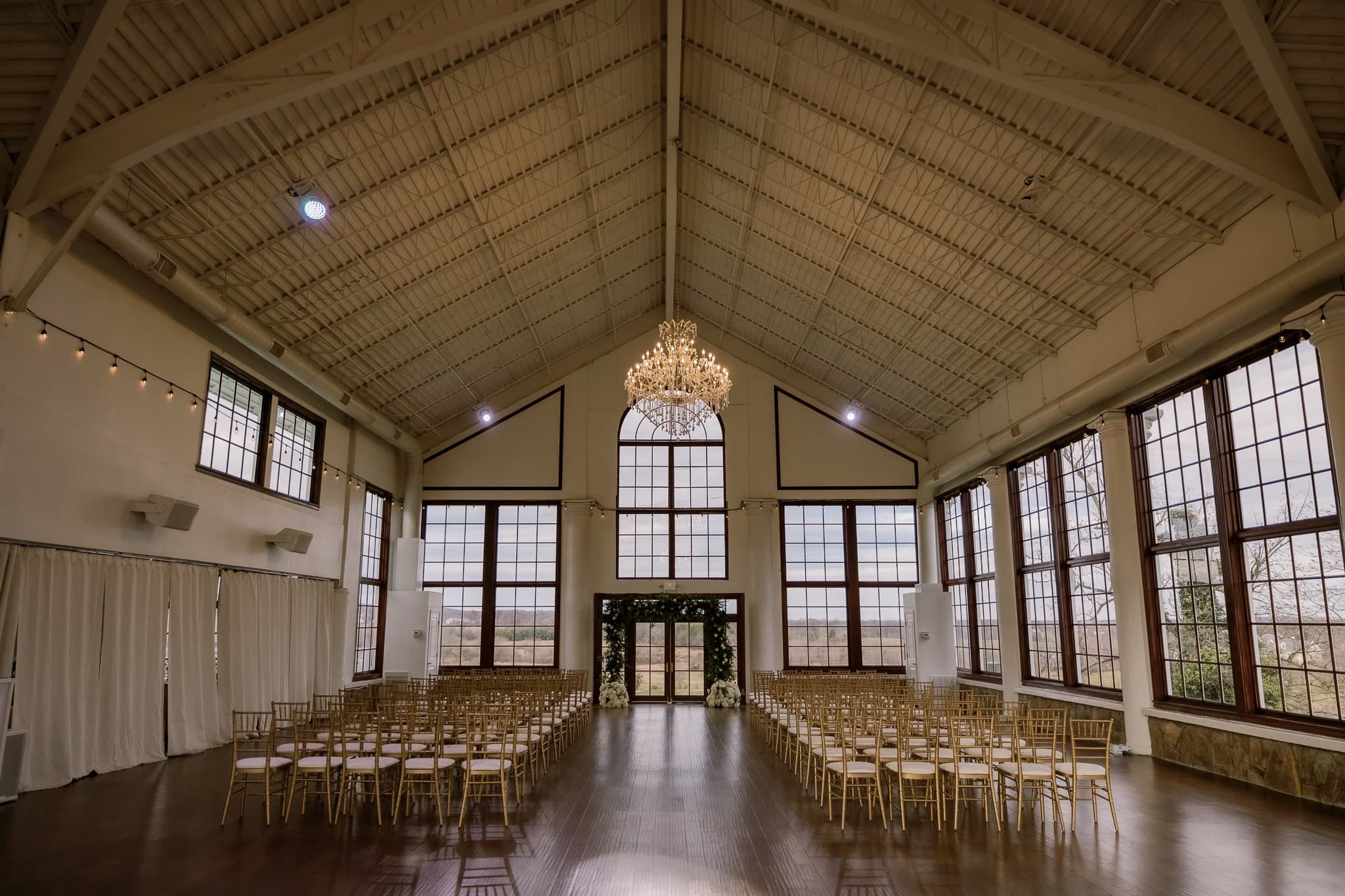 Empty glasshouse ceremony hall set with chairs