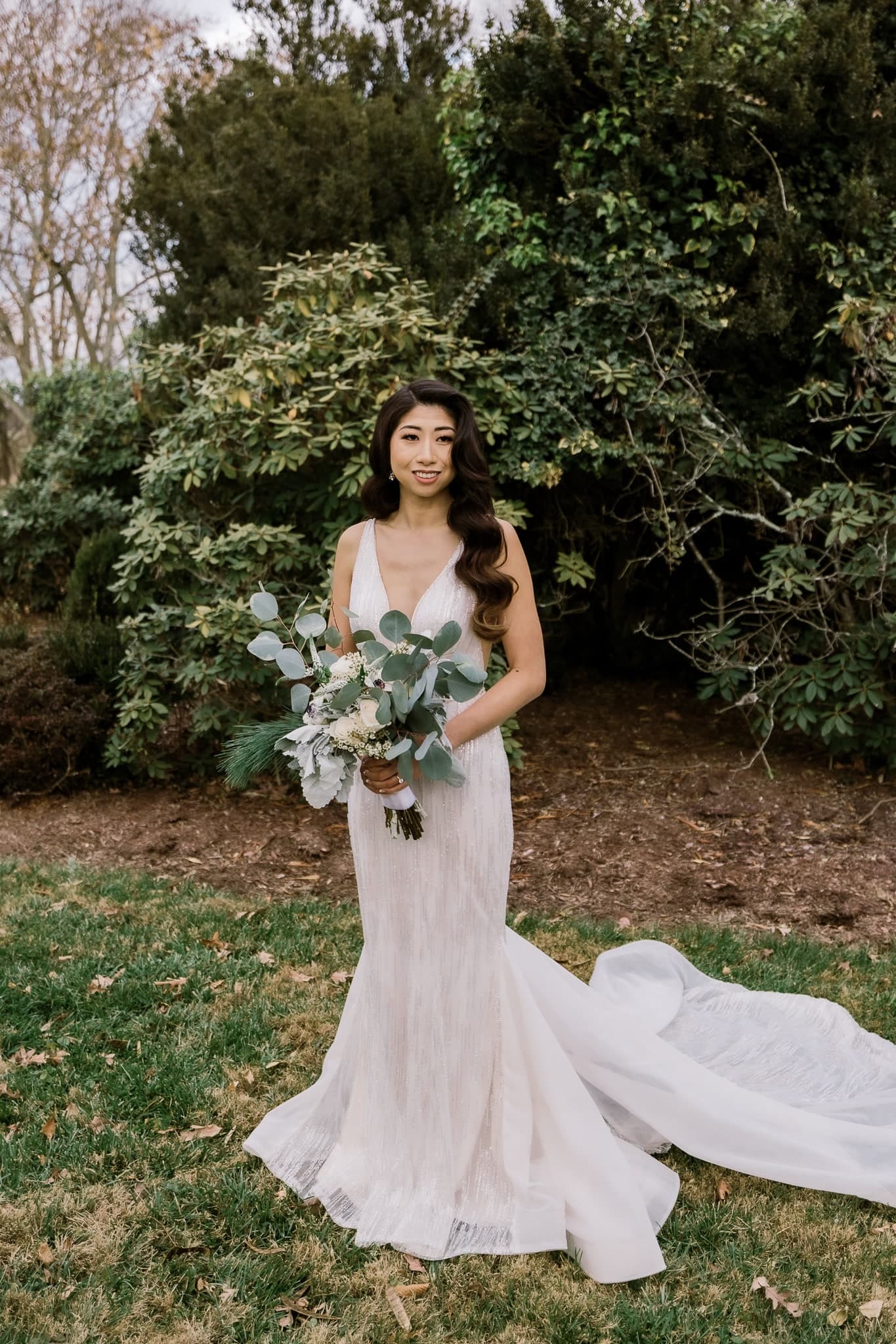 Bride in a fitted lace gown with a long train