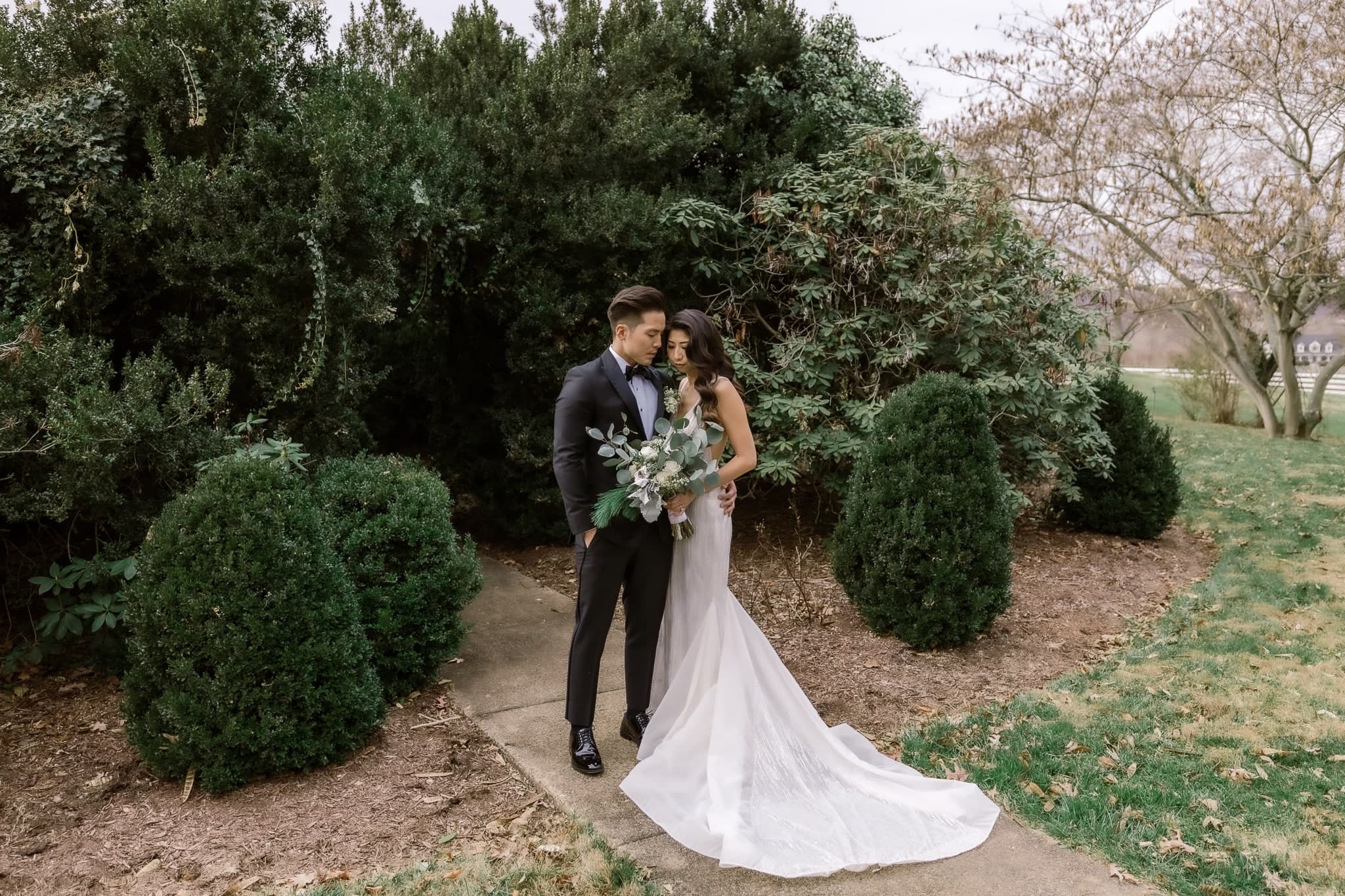 Couple in the garden among the evergreens
